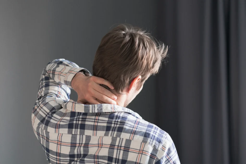 adult man massaging neck in home setting 2026 03 17 03 31 38 utc